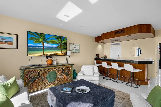 a spacious bedroom with a bed a couch and large window