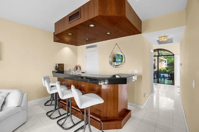 a bathroom with a tub a sink and a mirror