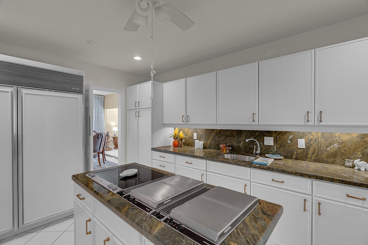 1 Ocean Lane Manalapan, FL 33462 - Photo 41 of 95 a kitchen with granite countertop a sink stainless steel appliances and cabinets