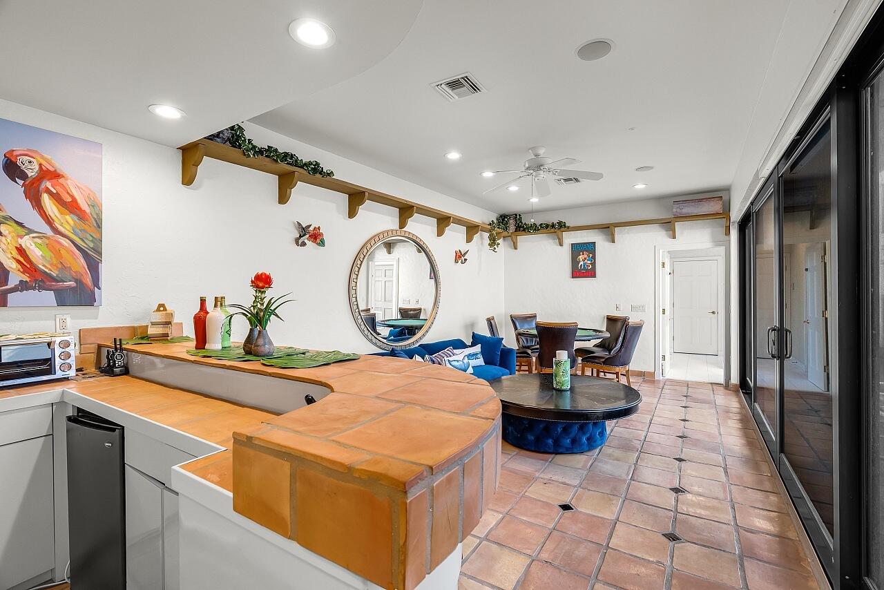 1 Ocean Lane Manalapan, FL 33462 - Photo 50 of 95 a kitchen with a table and chairs in it