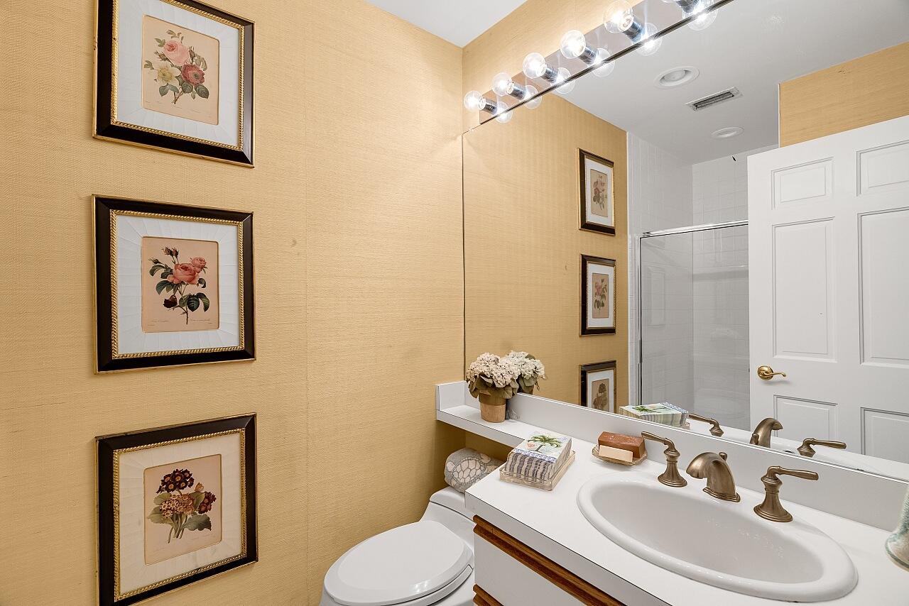 1 Ocean Lane Manalapan, FL 33462 - Photo 55 of 95 a bathroom with a sink mirror and toilet