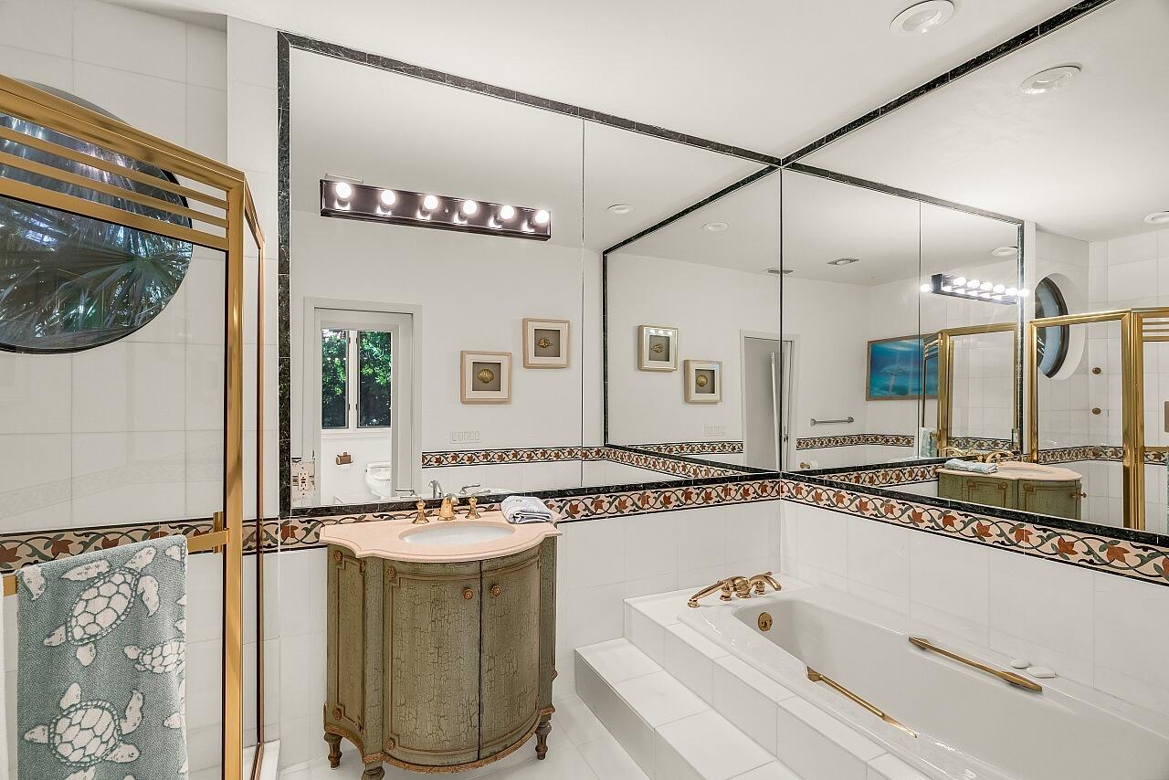 1 Ocean Lane Manalapan, FL 33462 - Photo 65 of 95 a bathroom with a tub a sink and a mirror