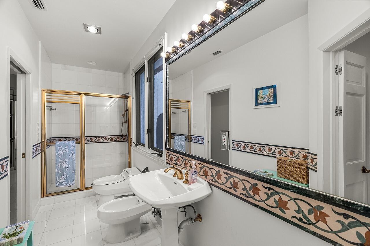 1 Ocean Lane Manalapan, FL 33462 - Photo 68 of 95 a bathroom with a sink and a mirror