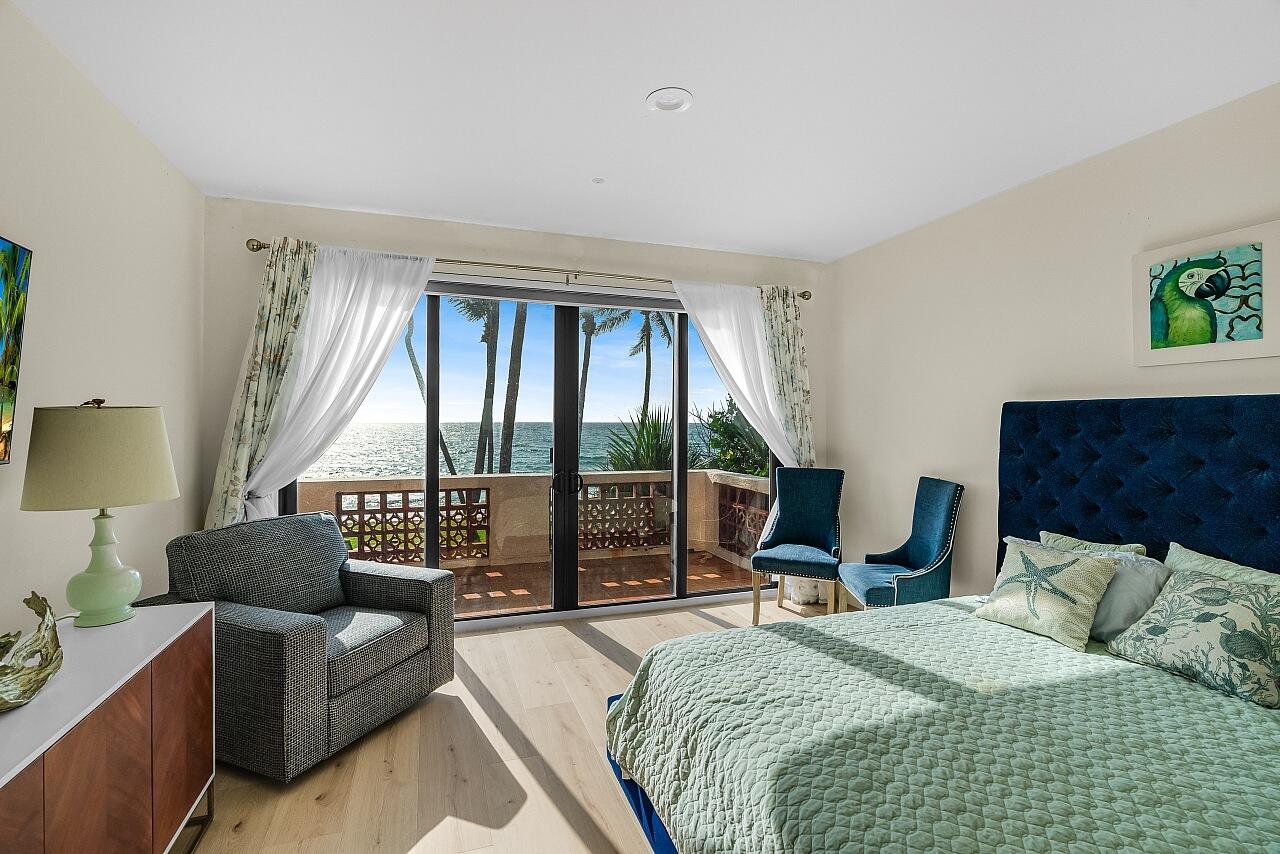 1 Ocean Lane Manalapan, FL 33462 - Photo 73 of 95 a bedroom with a bed and a large window with balcony view