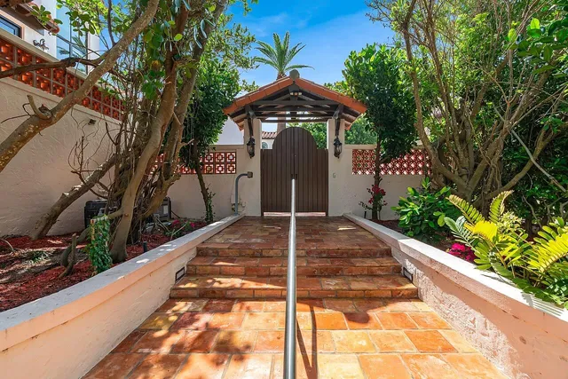 a view of a backyard with swimming pool and sitting area