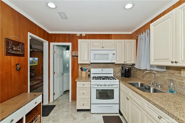 a kitchen with stainless steel appliances granite countertop a refrigerator sink and cabinets