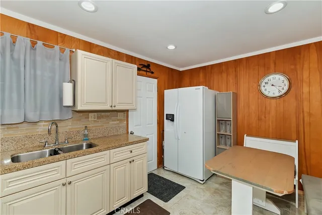 a kitchen with white cabinets and white appliances