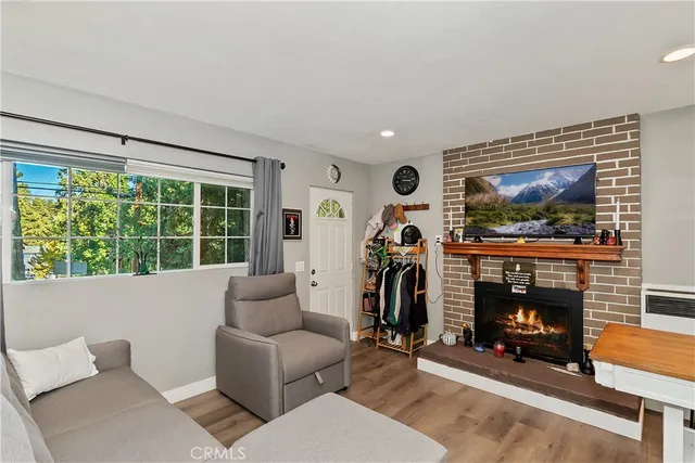 a living room with furniture a fireplace and a flat screen tv