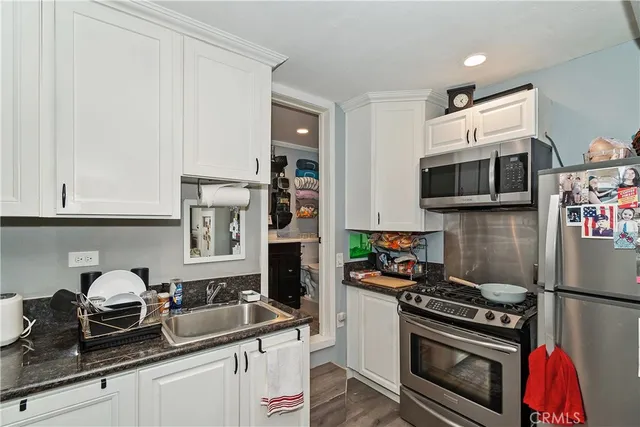 a backyard of a house with chairs and plants