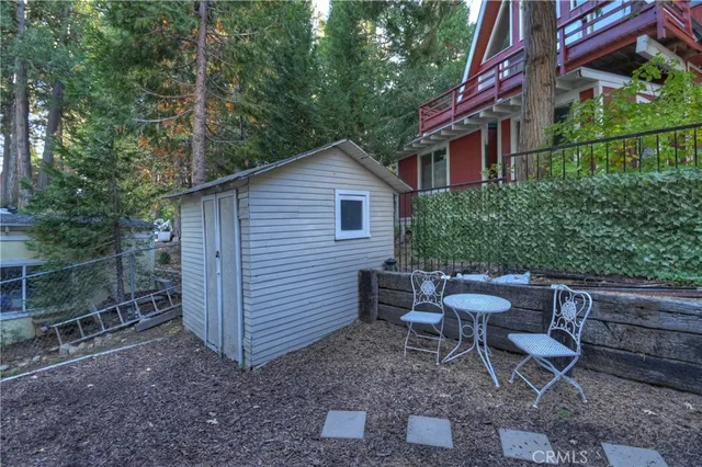 a view of a house with backyard and chairs