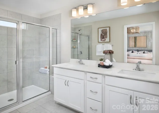 a bathroom with a shower sink and mirror
