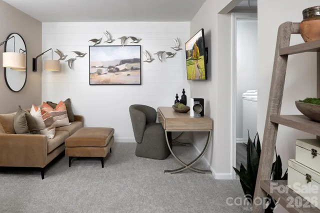 a living room with furniture a couch and a mirror