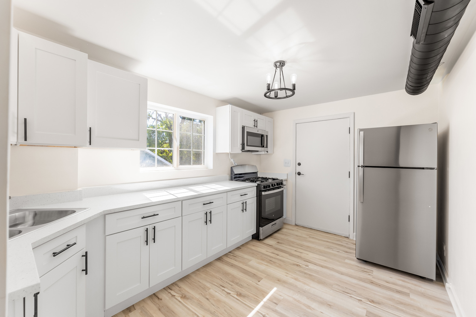 3243 Ridge Road, Unit 2 Lansing, IL 60438 - Photo 3 of 13 a kitchen with white cabinets and stainless steel appliances