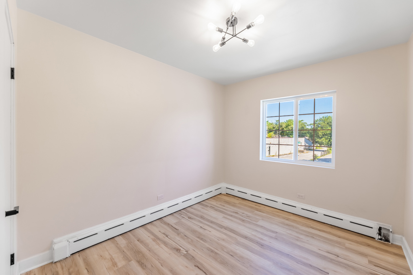 3243 Ridge Road, Unit 2 Lansing, IL 60438 - Photo 9 of 13 wooden floor in an empty room with a window