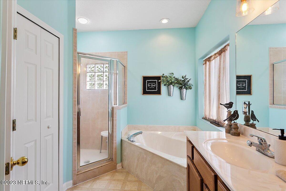 776 Constitution Place Macclenny, FL 32063 - Photo 12 of 30 a bathroom with a tub sink and mirror