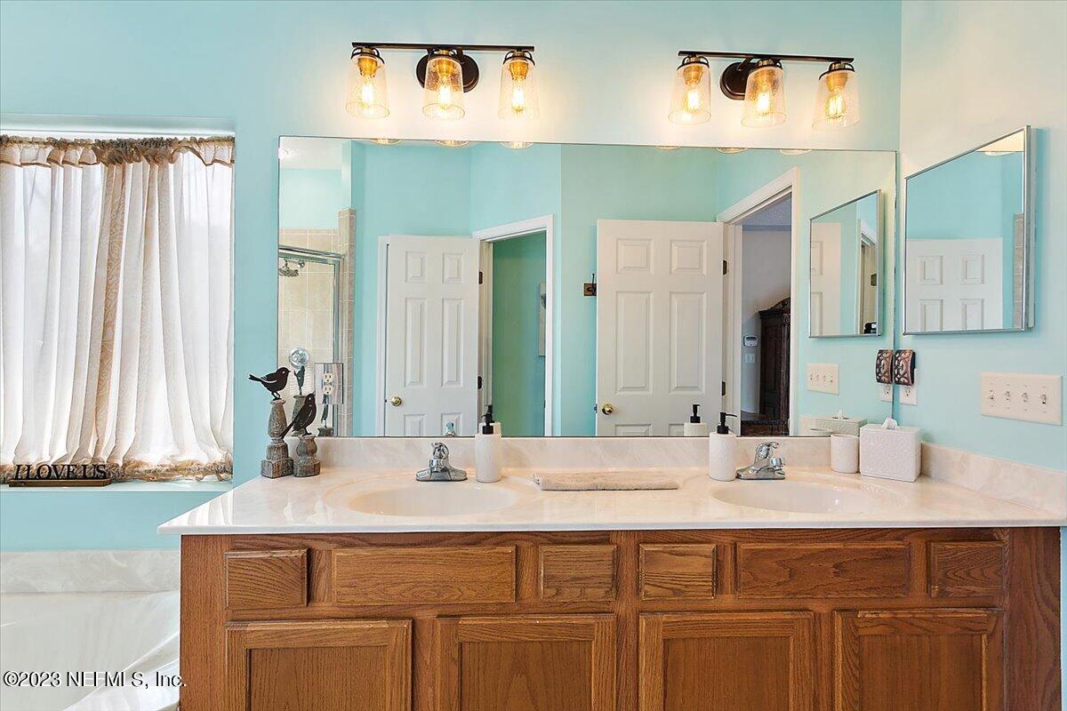 776 Constitution Place Macclenny, FL 32063 - Photo 13 of 30 a bathroom with a sink and a mirror