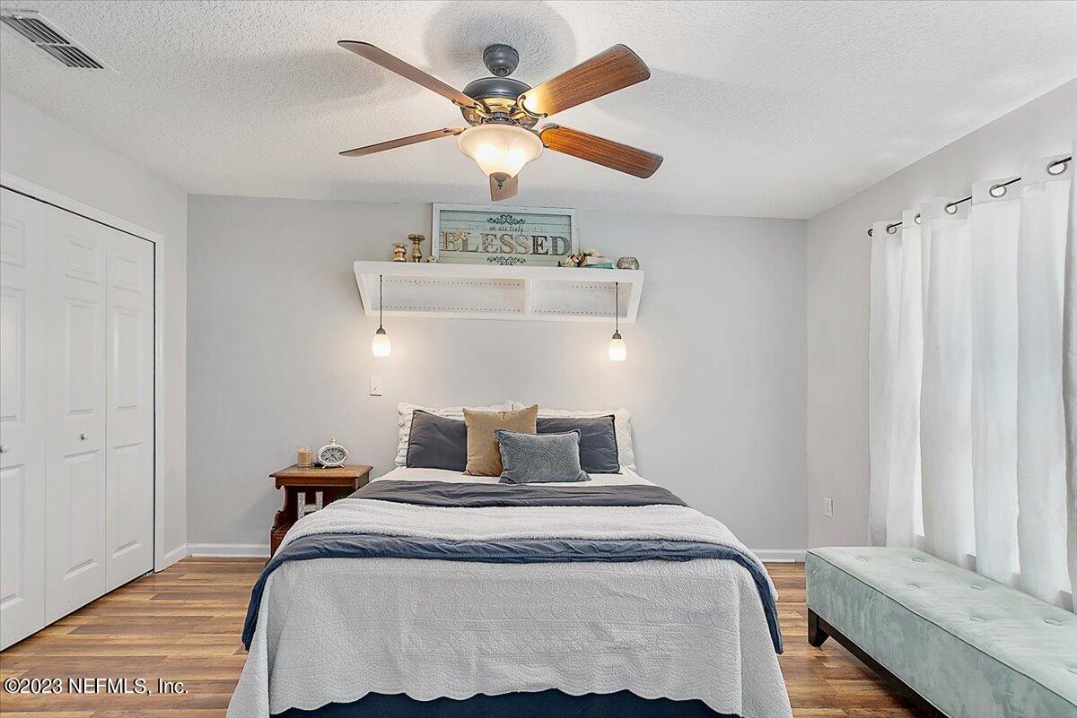 776 Constitution Place Macclenny, FL 32063 - Photo 15 of 30 a bedroom with a bed and a chandelier