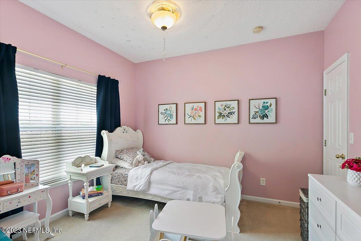 776 Constitution Place Macclenny, FL 32063 - Photo 17 of 30 a bedroom with a bed and wooden floor