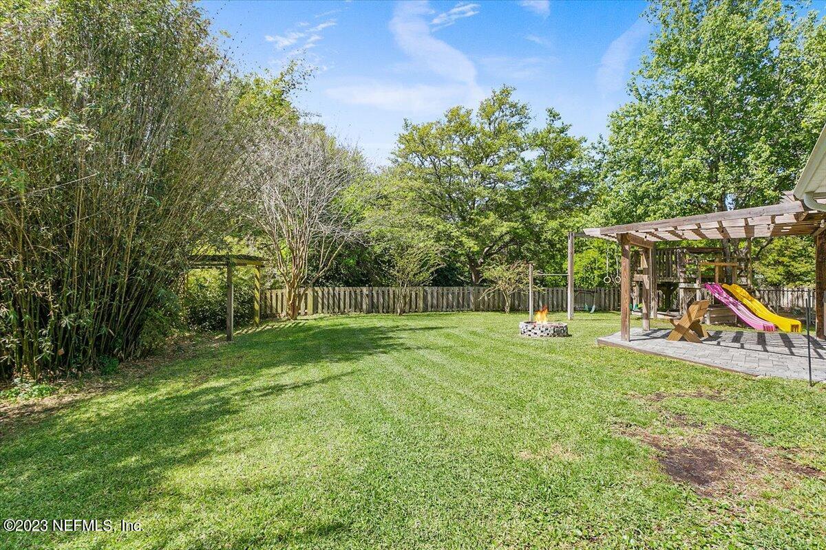 776 Constitution Place Macclenny, FL 32063 - Photo 22 of 30 a view of a backyard with swings