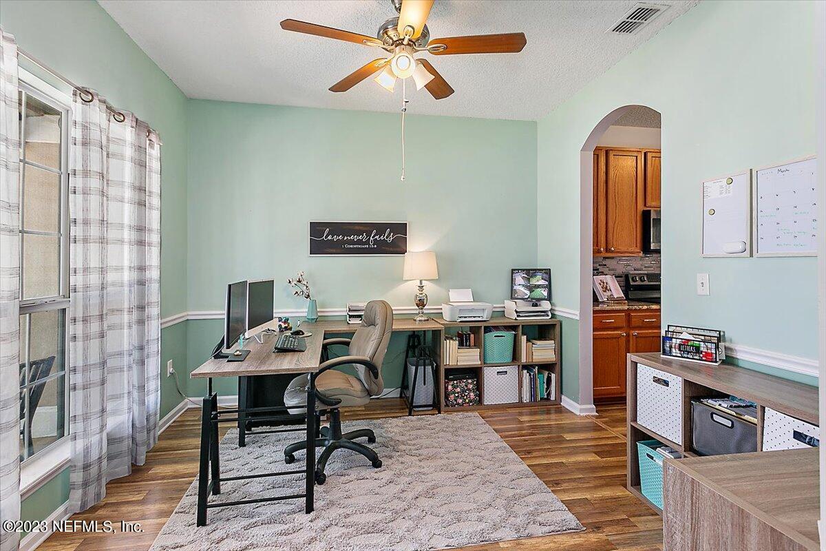 776 Constitution Place Macclenny, FL 32063 - Photo 5 of 30 a work room with furniture and wooden floor