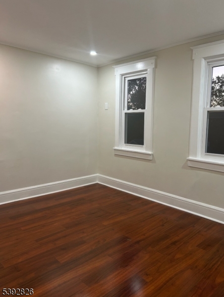 904 Cross Elizabeth, NJ 07208 - Photo 11 of 27 a view of an empty room with wooden floor and a window