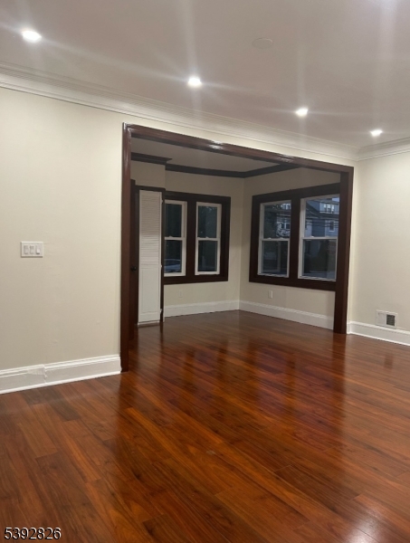 904 Cross Elizabeth, NJ 07208 - Photo 4 of 27 an empty room with wooden floor and windows