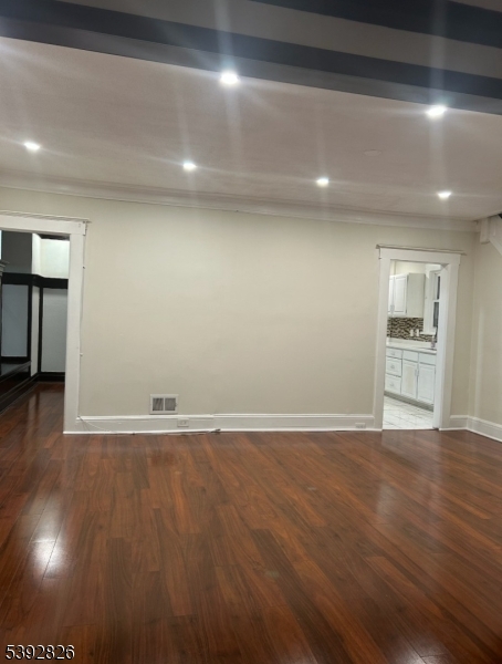 904 Cross Elizabeth, NJ 07208 - Photo 10 of 27 a view of an empty room with wooden floor and a window