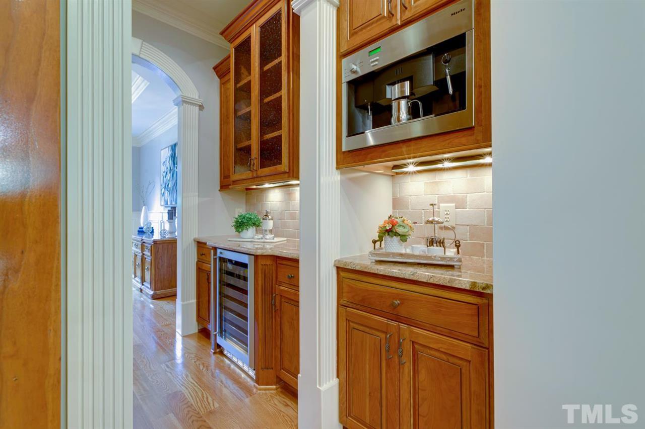1317 Caistor Lane Raleigh, NC 27614 - Photo 4 of 22 Built in Miele coffee machine with counter space and a butler's pantry with wine fridge. Perfect for entertaining family & friends.