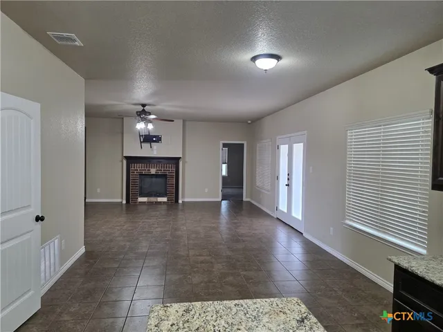 a view of a livingroom with furniture and a ceiling fan