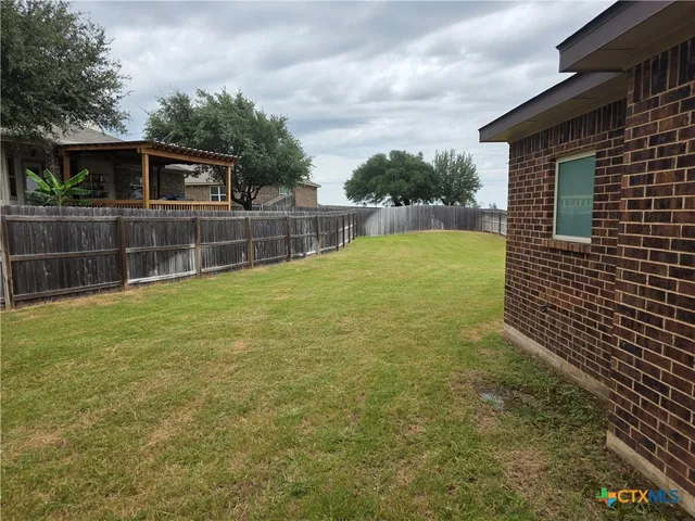 a view of house with backyard and entertaining space