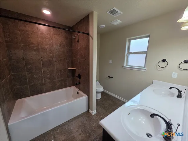 a bathroom with a sink and a bathtub