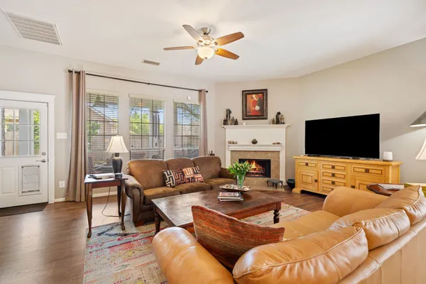 a living room with furniture wooden floor and a flat screen tv