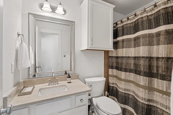 a bedroom with bed and a chandelier