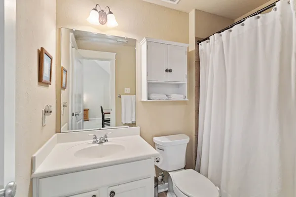 a bedroom with a bed flat screen tv and a large window