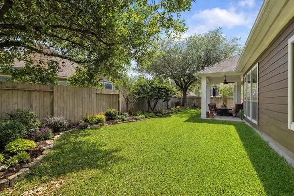 a view of a house with backyard porch and garden