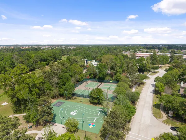 a view of a city with lush green forest