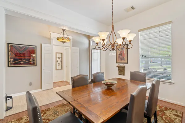 a view of a dining room with furniture window and wooden floor