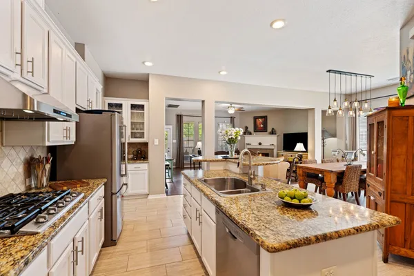 a kitchen with stainless steel appliances granite countertop a sink stove and refrigerator