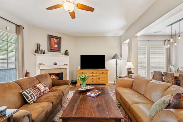 a living room with furniture a flat screen tv and a fireplace