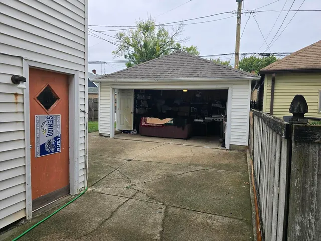 a view of a house with a garage and a fireplace