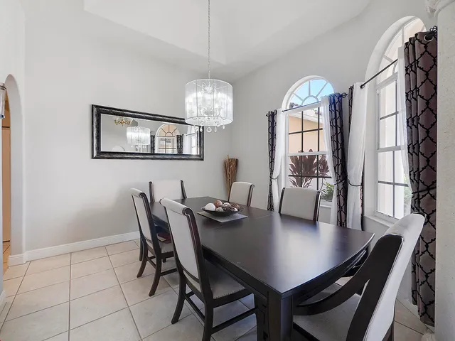 a view of a dining room with furniture and chandelier
