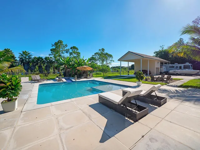 a view of a patio with couches and potted plants
