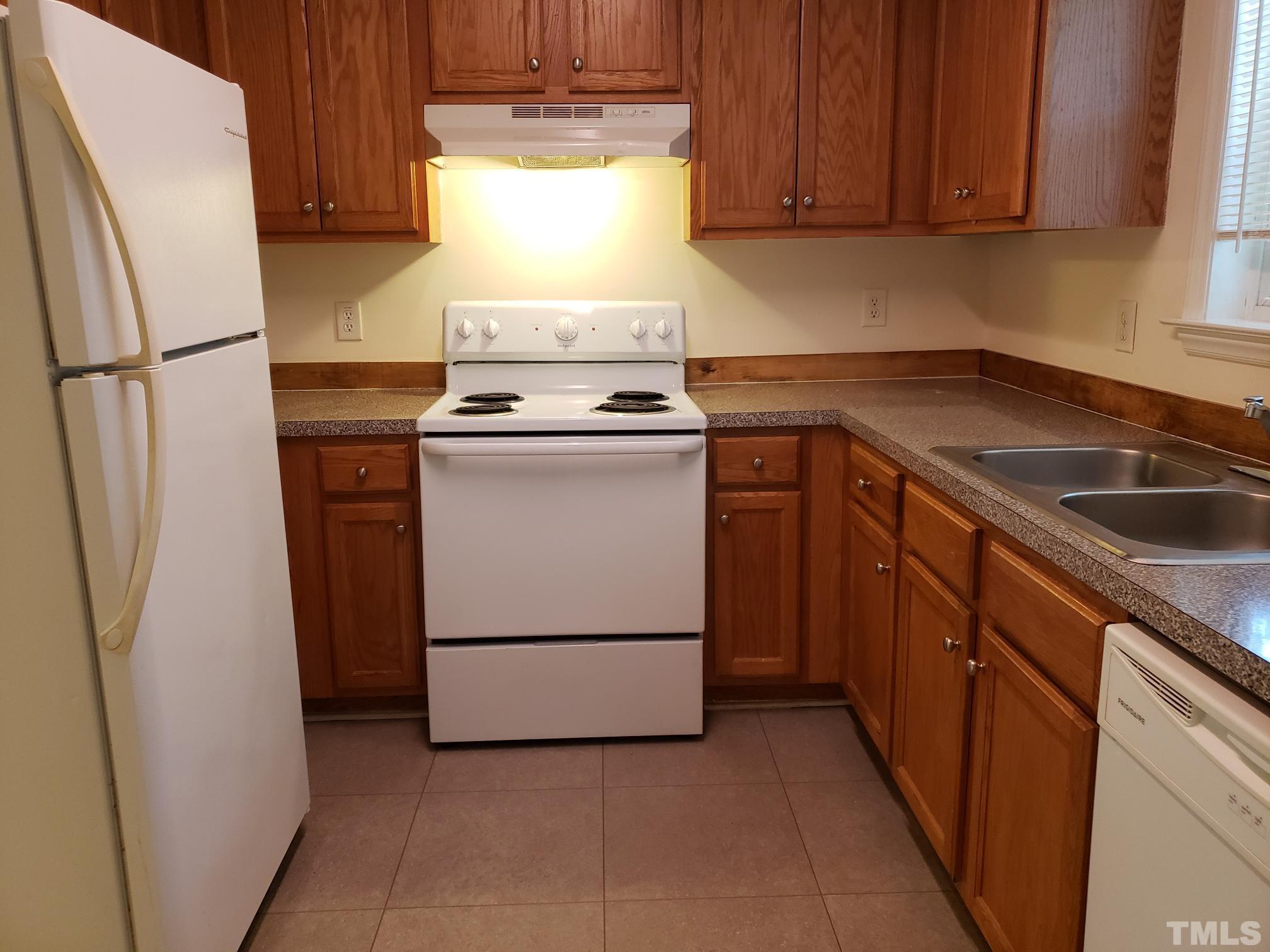 542 Barnes Lake Road, Unit B Middlesex, NC 27557 - Photo 3 of 16 a kitchen with a refrigerator sink stove and cabinets