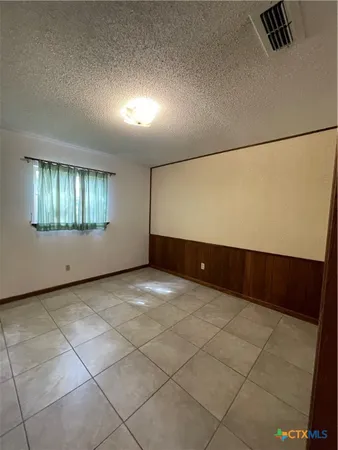 a view of an empty room with windows