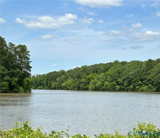 a view of a field with a tree in it