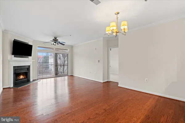a view of an empty room with a fireplace and a window