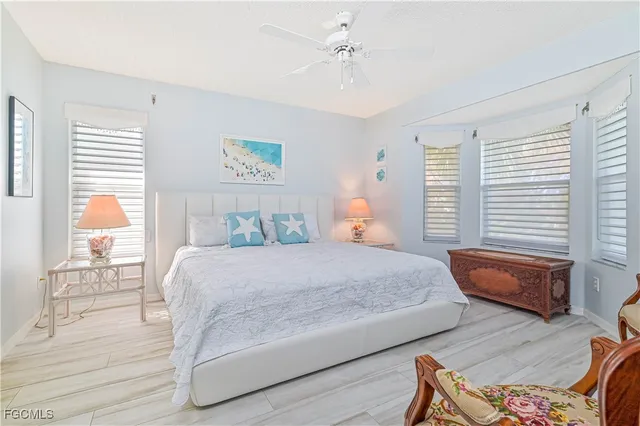 a bedroom with a bed wooden floor and window