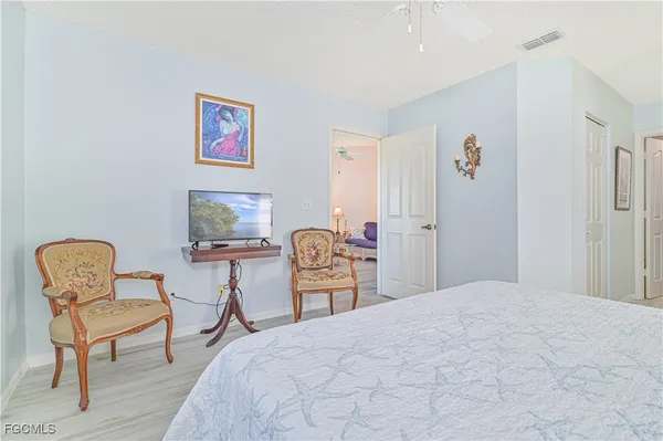 a bedroom with a bed and chair chair