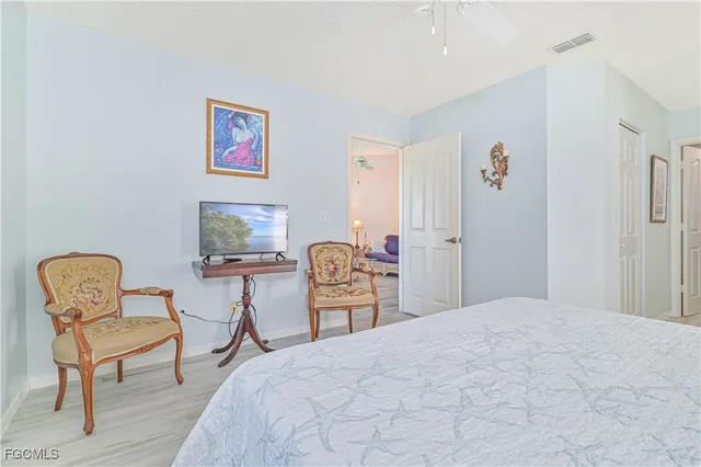 a bedroom with a bed and chair chair