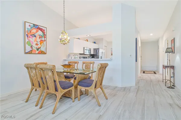 a view of a dining room with furniture wooden floor and a chandelier